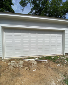 A newly installed white panel garage door on a residential property by J&C Bravo LLC in Cordova, TN.