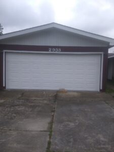 A newly installed white panel garage door on a residential property by Residential WorX LLC in Westlake, LA.