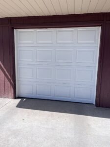 A newly installed white residential garage door, showcasing quality work by Pham Garage Door Service & Repair in Arvada, CO.