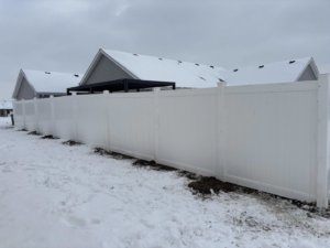 A new white vinyl fence installation providing privacy for a residential backyard by H&M Fencing LLC in Decatur, IN.