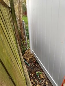 A new white vinyl fence installed next to an older wooden fence by Pride Fence LLC in Overland Park, KS.