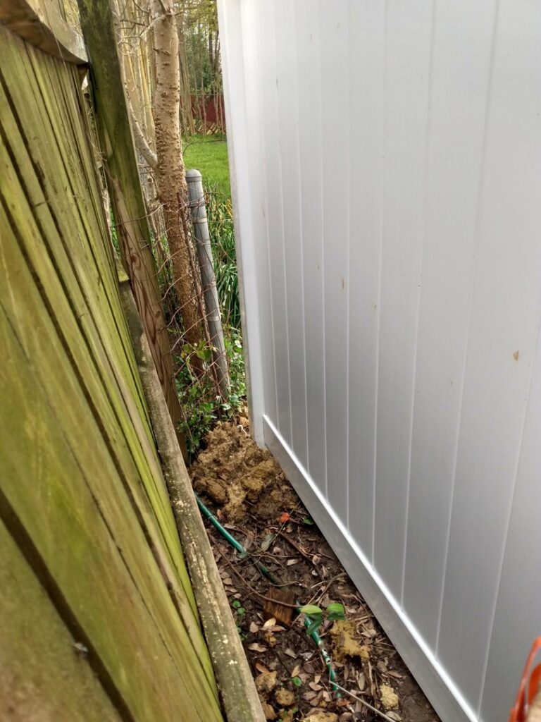 A new white vinyl fence installed next to an older wooden fence by Pride Fence LLC in Overland Park, KS.