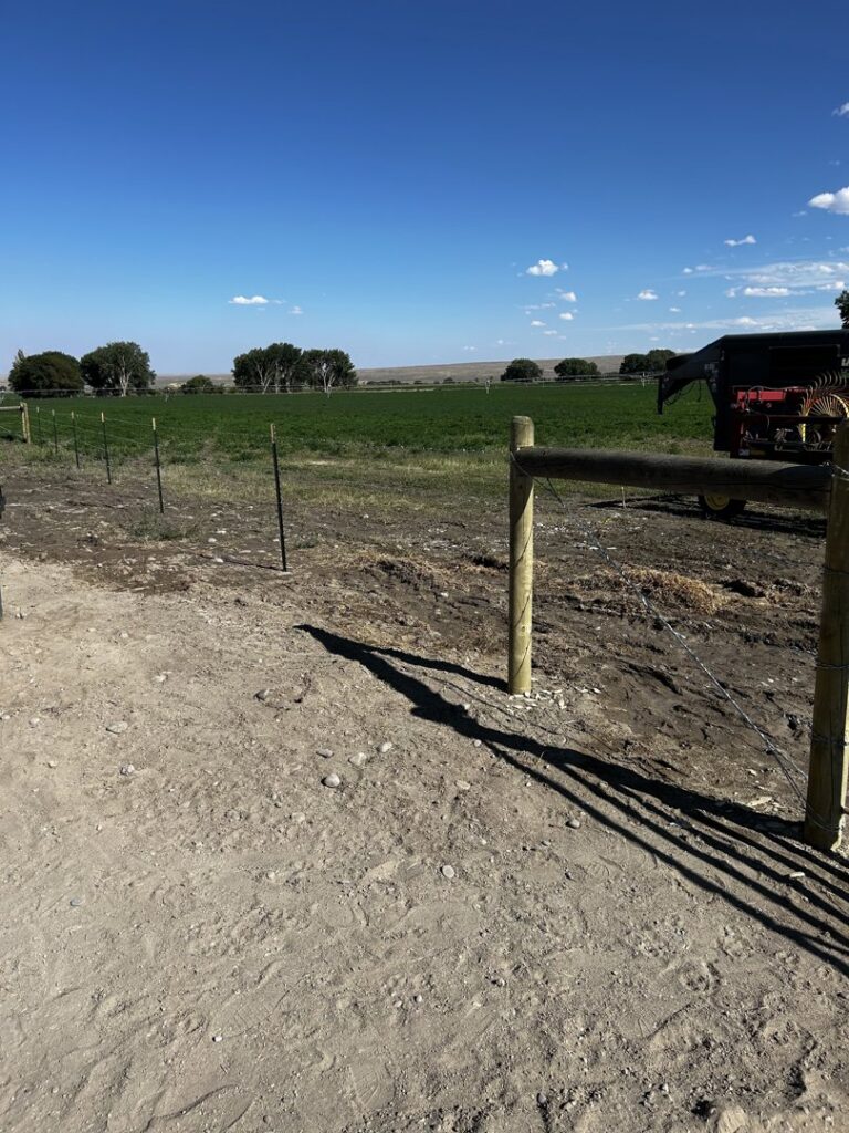 New wire fence installation with wooden and T-posts by Cowboy State Fencing LLC in Riverton, WY.