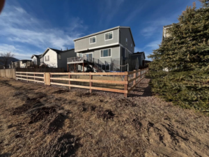 A new wood and wire mesh fence installed around a backyard by Denfence Team in Colorado Springs, CO