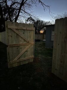 A newly installed wood backyard gate with diagonal bracing, providing secure access by G L Fence & Remodeling in Arlington, TX.