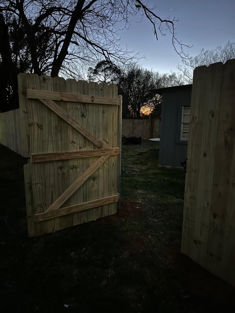 A newly installed wood backyard gate with diagonal bracing, providing secure access by G L Fence & Remodeling in Arlington, TX.