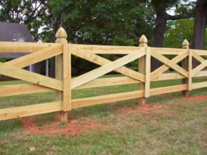 A newly installed light-colored wooden cross-buck ranch fence by United Fence Company in Johnston, RI.