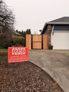 A new wood fence and gate installation with an RPB Fence sign in front of a home in Salem, OR
