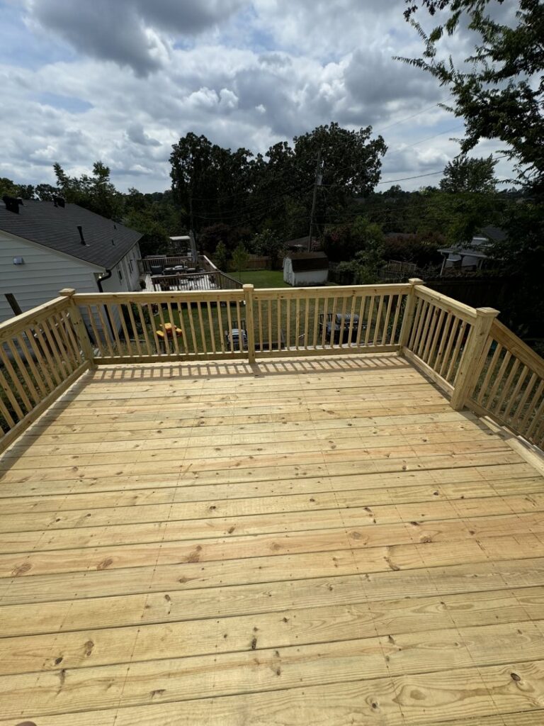 A newly installed wood fence enclosing a residential backyard, viewed from a deck, by Faithful Fencing LLC in Batesville, AR.