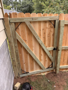 A newly installed wood fence gate with diagonal bracing by 218 Fencing in Duluth, MN.