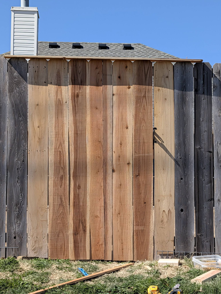 A newly installed wood fence gate section by Black and Sons fencing in Indiahoma, OK.