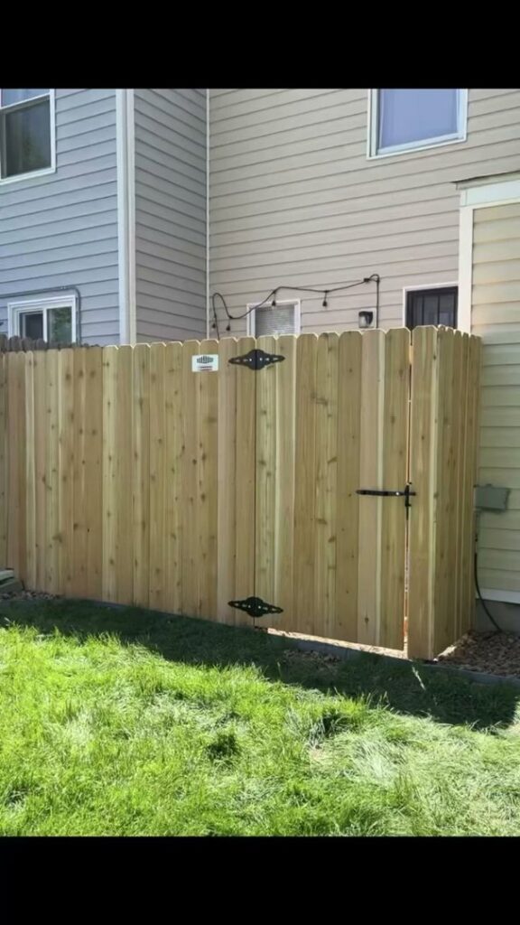 A newly installed wood fence and gate in a residential area by Supreme Fencing Denver, CO.