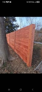 A new wood fence installation in a residential area by Fencing Company Of Omaha in Omaha, NE.
