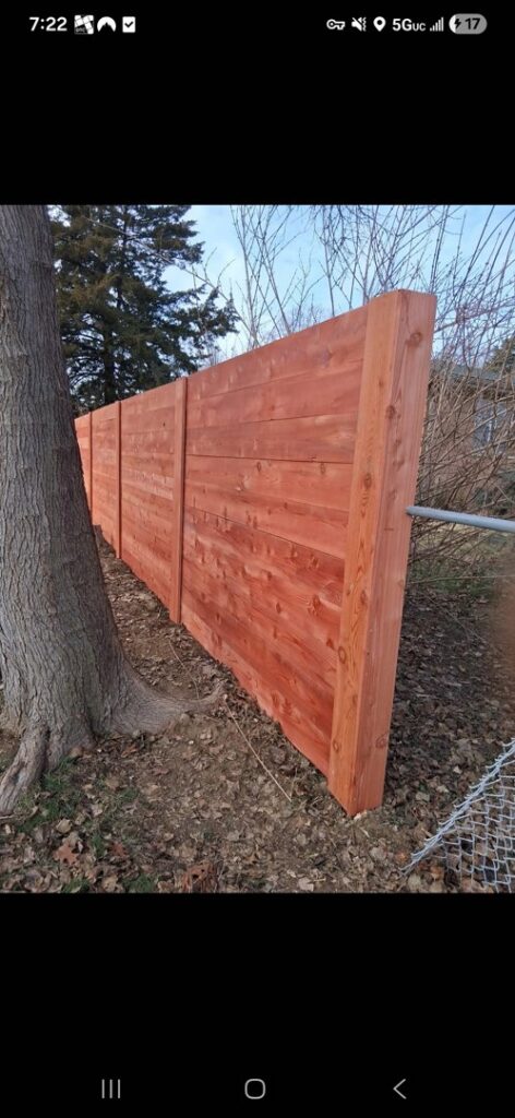 A new wood fence installation in a residential area by Fencing Company Of Omaha in Omaha, NE.