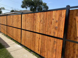A newly installed wood fence with black metal posts by Superior Custom Fence Inc. in Chicago, IL.