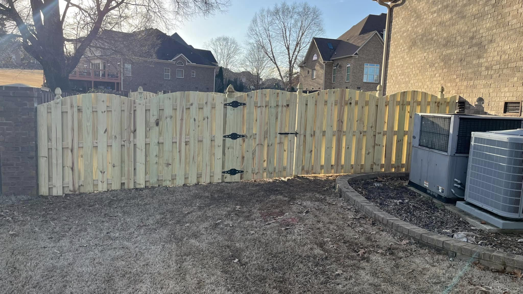 A newly installed wood fence with a single gate by Precision Contracting LLC in Jupiter, FL, near an AC unit.