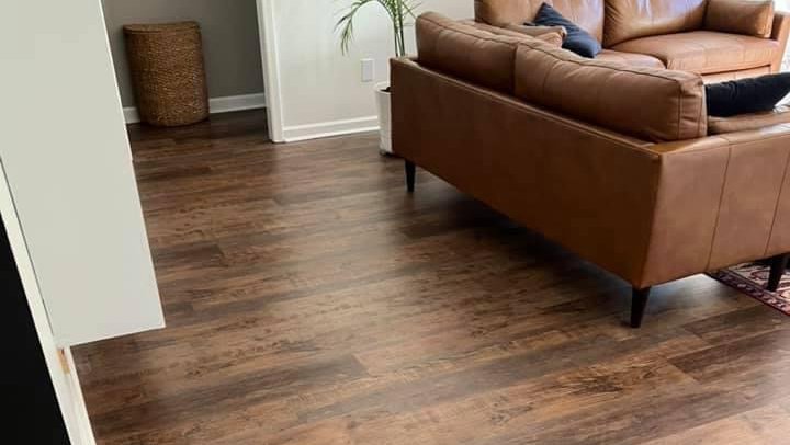 Newly installed wood-look flooring in a living room by Trent's Carpet Cleaning & Restoration in Fishers, IN.