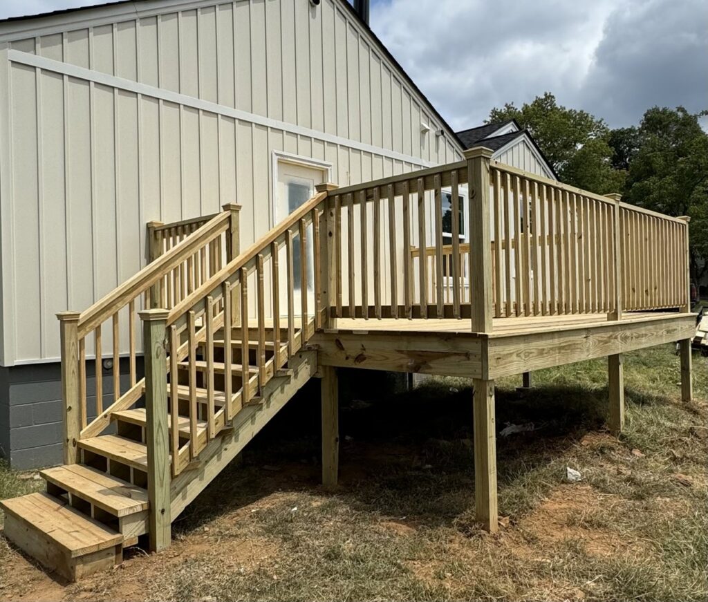 A newly installed wood picket fence and gate, featuring black hardware, by Faithful Fencing LLC in Batesville, AR.