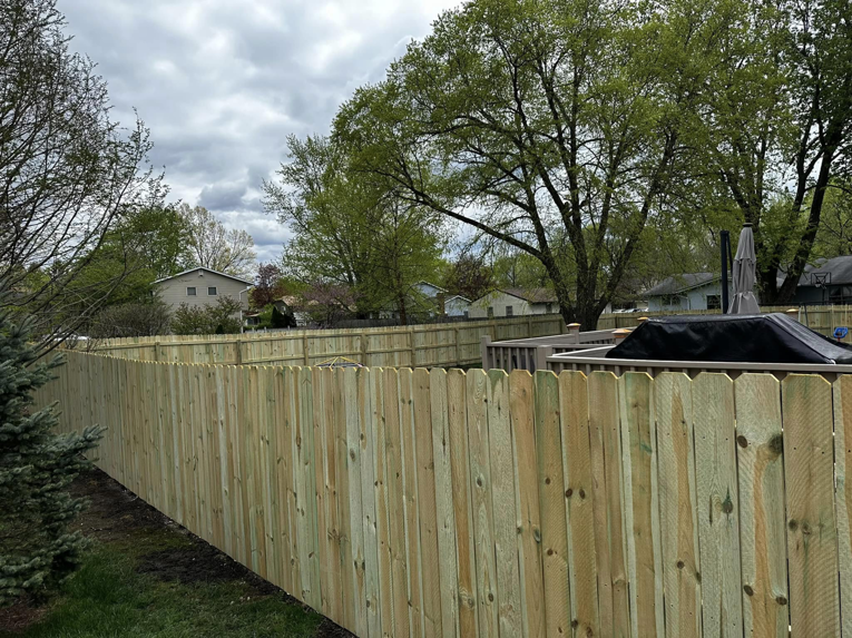 A newly installed wood picket fence providing privacy in a backyard by CDM Home Solutions in Columbus, OH.