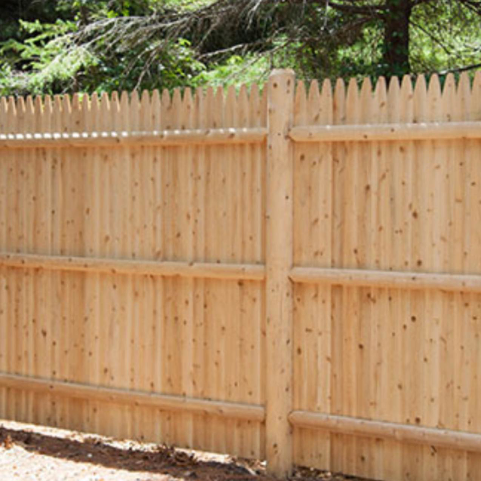 A newly installed wood picket fence by Done Right Inc., a professional fencing contractor in Lowell, IN.