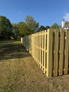 A newly installed wood picket fence in a residential backyard by Faithful Fencing LLC in Batesville, AR.