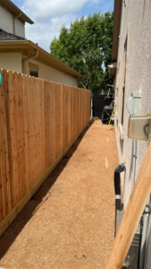 A long, newly installed wooden privacy fence along a residential property by Alexi's Handyman Services in Indianapolis, IN.