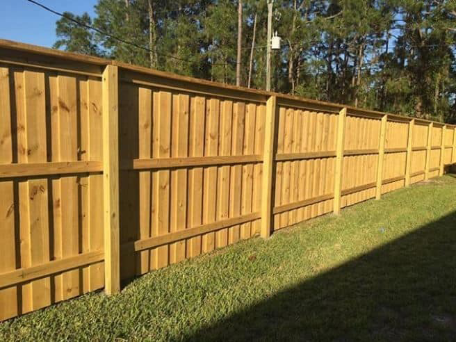 A newly installed wood privacy fence in a residential backyard by Freedom Fencing of Clarksville, TN.
