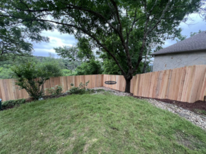 A newly installed wood privacy fence in a residential backyard by K.K. Landscaping & Fencing in Austin, TX.