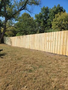 A long, newly installed wood privacy fence in a backyard by Lujan Fencing in Independence, MO.