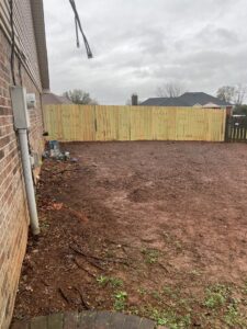 A newly installed wood privacy fence in a residential backyard, completed by RUCO Fence in Huntsville, AL.