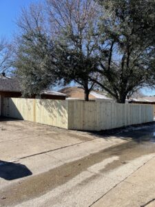 A newly installed wood privacy fence forming a clean corner by Franco Fence in Garland, TX.