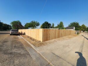 A newly installed wooden privacy fence on a corner residential lot by Josey's Fencing LLC in Caldwell, ID.