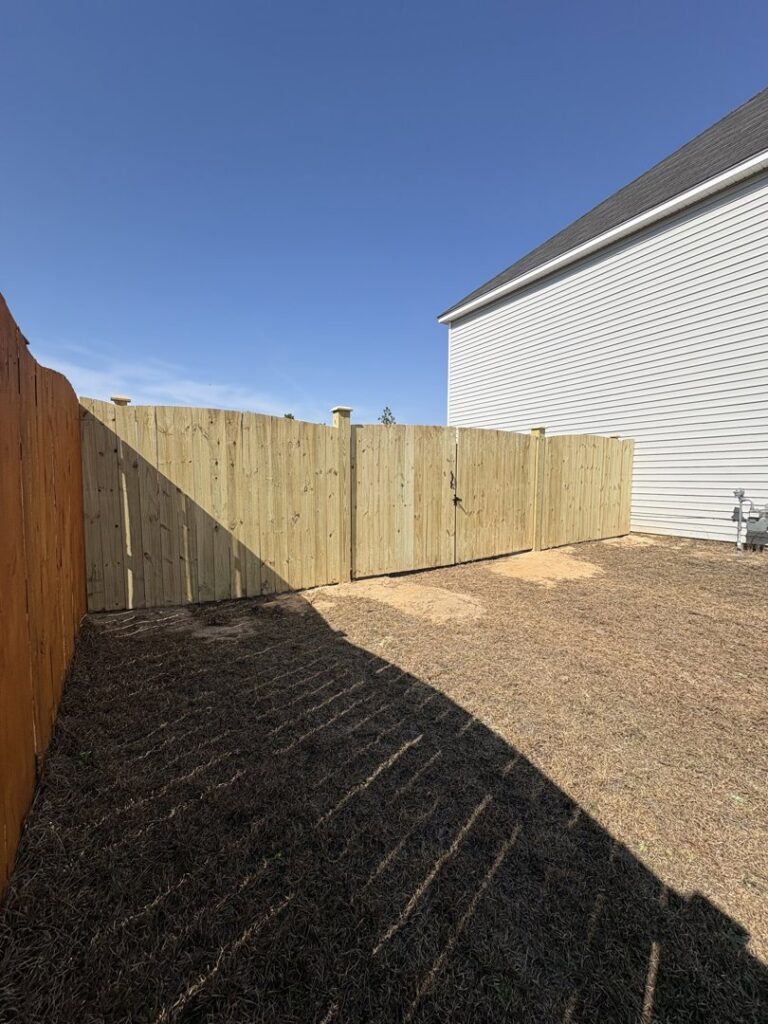 A new wood privacy fence featuring a double gate installed by Covenant Fence in Columbia, SC.