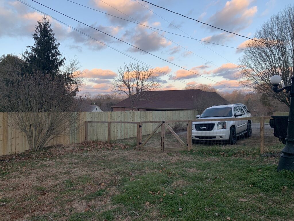 A newly installed wood privacy fence with a matching gate by America's Fencing in Nashville, TN.