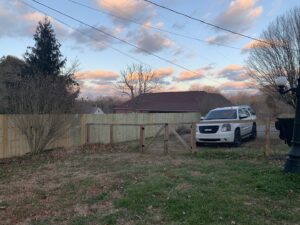 A newly installed wood privacy fence with a matching gate by America's Fencing in Nashville, TN.