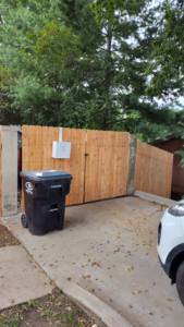 A newly installed wood privacy fence with a gate by Lujan Fencing in Independence, MO.
