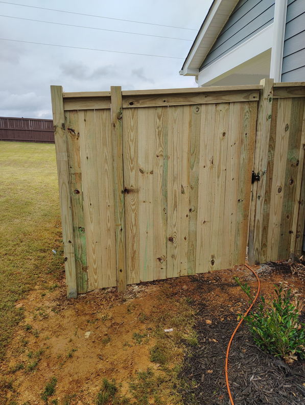 A newly installed wood privacy fence gate in a backyard by Maine Wood Fencing & more in Greenville, SC.
