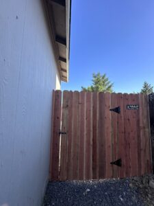 A newly installed wooden privacy fence gate, showcasing quality craftsmanship by Mule Fence Inc. in Sparks, NV.