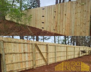 A new wood privacy fence with a gate installed in a wooded area by R&R Fence & Stain LLC in Madison, AL.