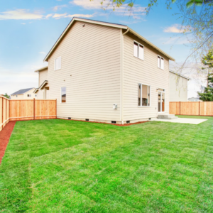 A newly installed wood privacy fence surrounding a backyard by All Out Companies, LLC. in Fernley, NV.