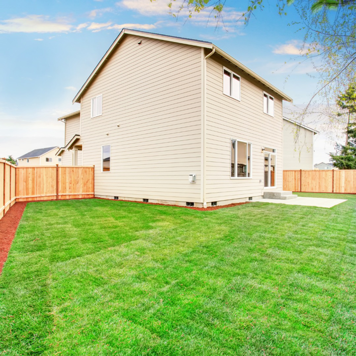 A newly installed wood privacy fence surrounding a backyard by All Out Companies, LLC. in Fernley, NV.