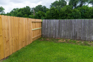 A new wooden privacy fence installed next to an older fence by Border Fence, Inc. in Greeley, CO.