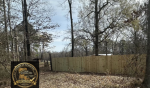 A newly installed wood privacy fence in a natural setting by C & M Affordable Fence, LLC in Haughton, LA