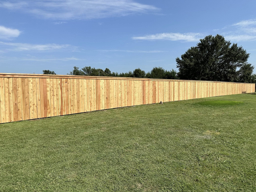 A newly installed wood privacy fence by DB Construction in Fort Smith, AR.