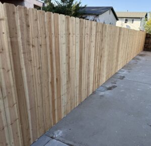 A newly installed wood privacy fence by Fence Tech in Everett, WA, providing a secure backyard.