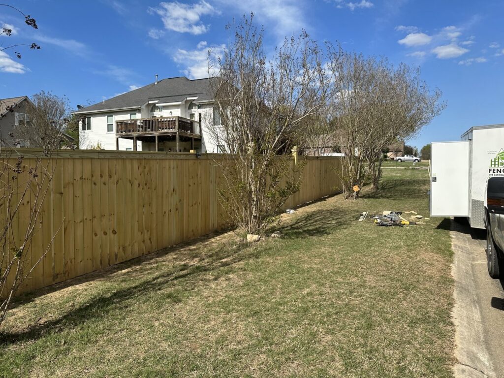 A newly installed wood privacy fence in a residential setting by Fences & Landscape Inc in Little Rock, AR.