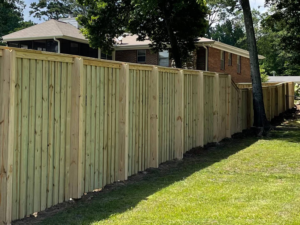 A newly installed wood privacy fence in a residential backyard by First Class Fence and Landscape LLC in Birmingham, AL.