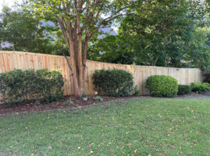 A newly installed wood privacy fence in a backyard by First in Fencing and Remodeling in Fayetteville, NC.