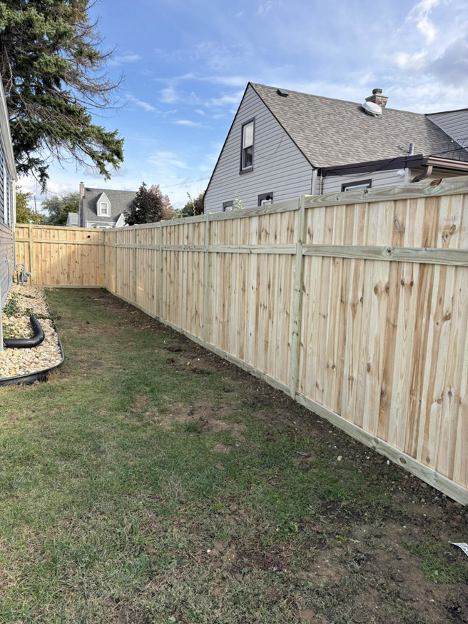 A newly installed wood privacy fence in a backyard by GoldHammer, a fencing contractor in Sebastopol, CA.
