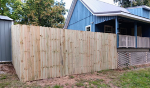 A newly installed wood privacy fence by Higdon's fence install & repair in White Mills Junction, KY